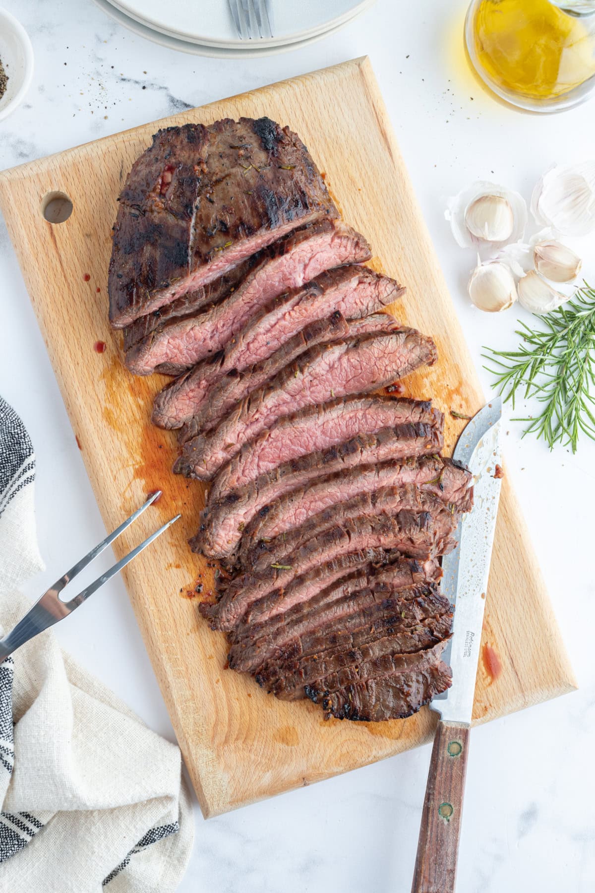 sliced flank steak on a board