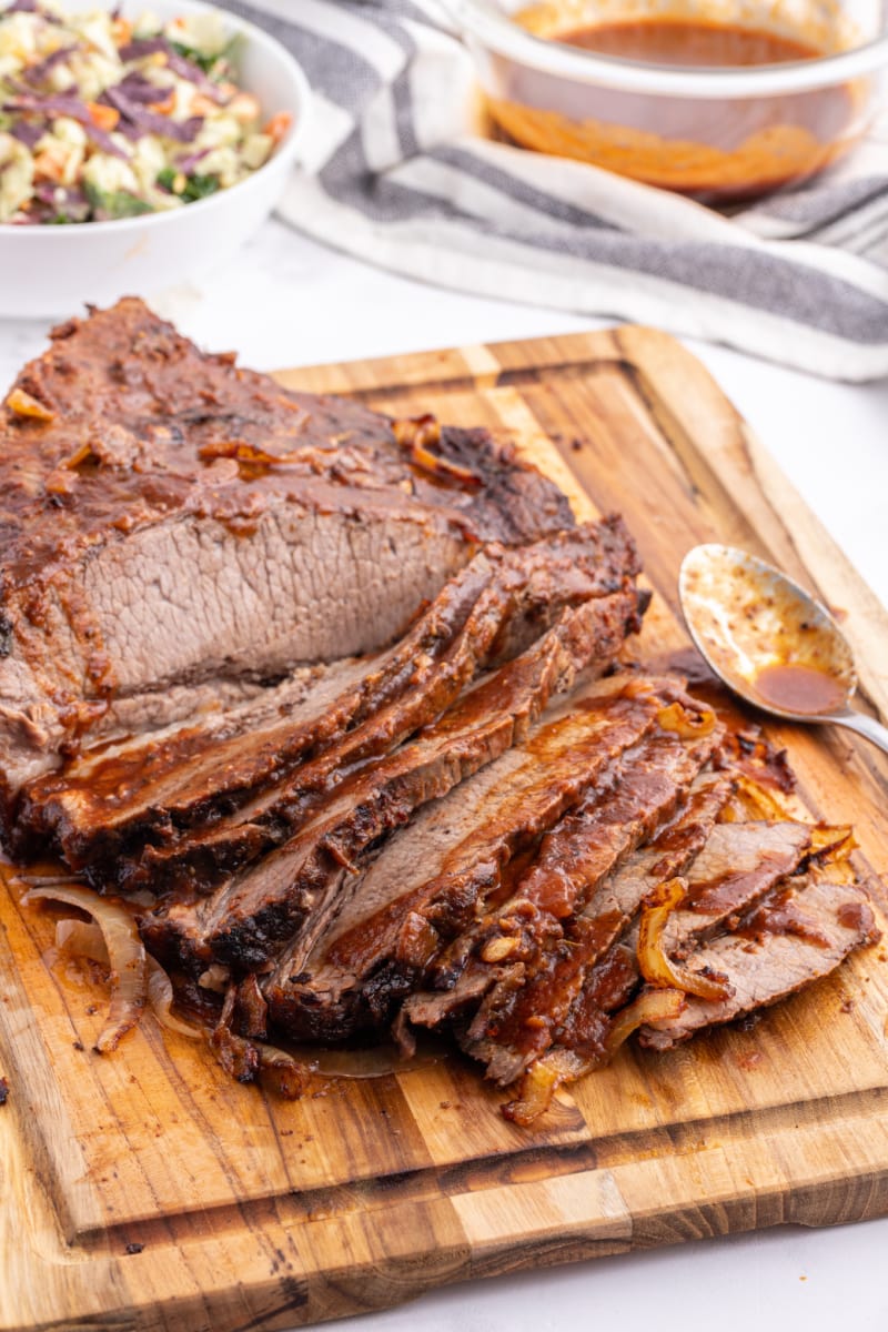 oven baked barbecue brisket on a cutting board sliced