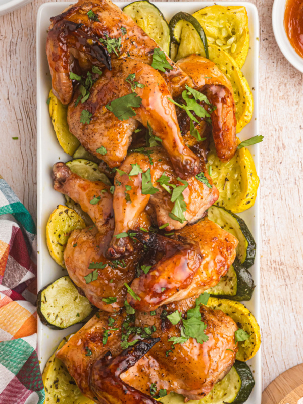 roasted apricot ginger glazed game hens on a platter with veggies