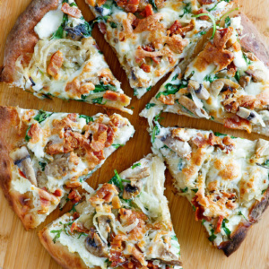 overhead shot of white pizza sliced on a cutting board