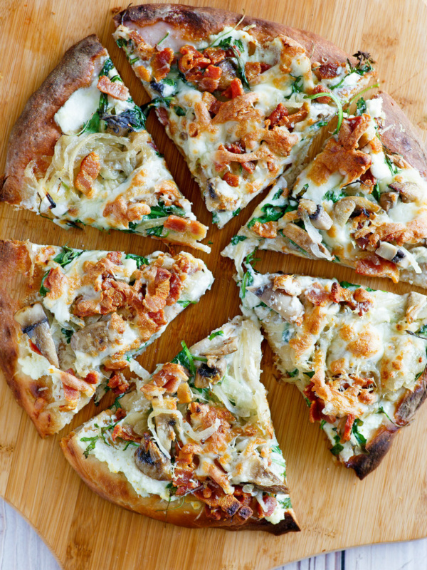 overhead shot of white pizza sliced on a cutting board