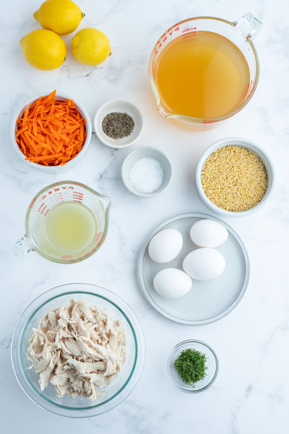 ingredients displayed for making greek orzo and chicken soup