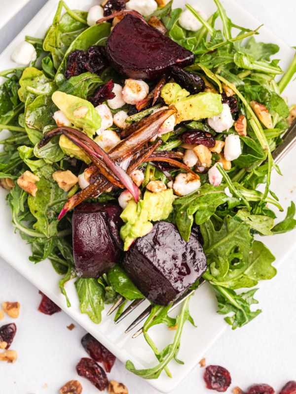 beet and goat cheese arugula salad on plate