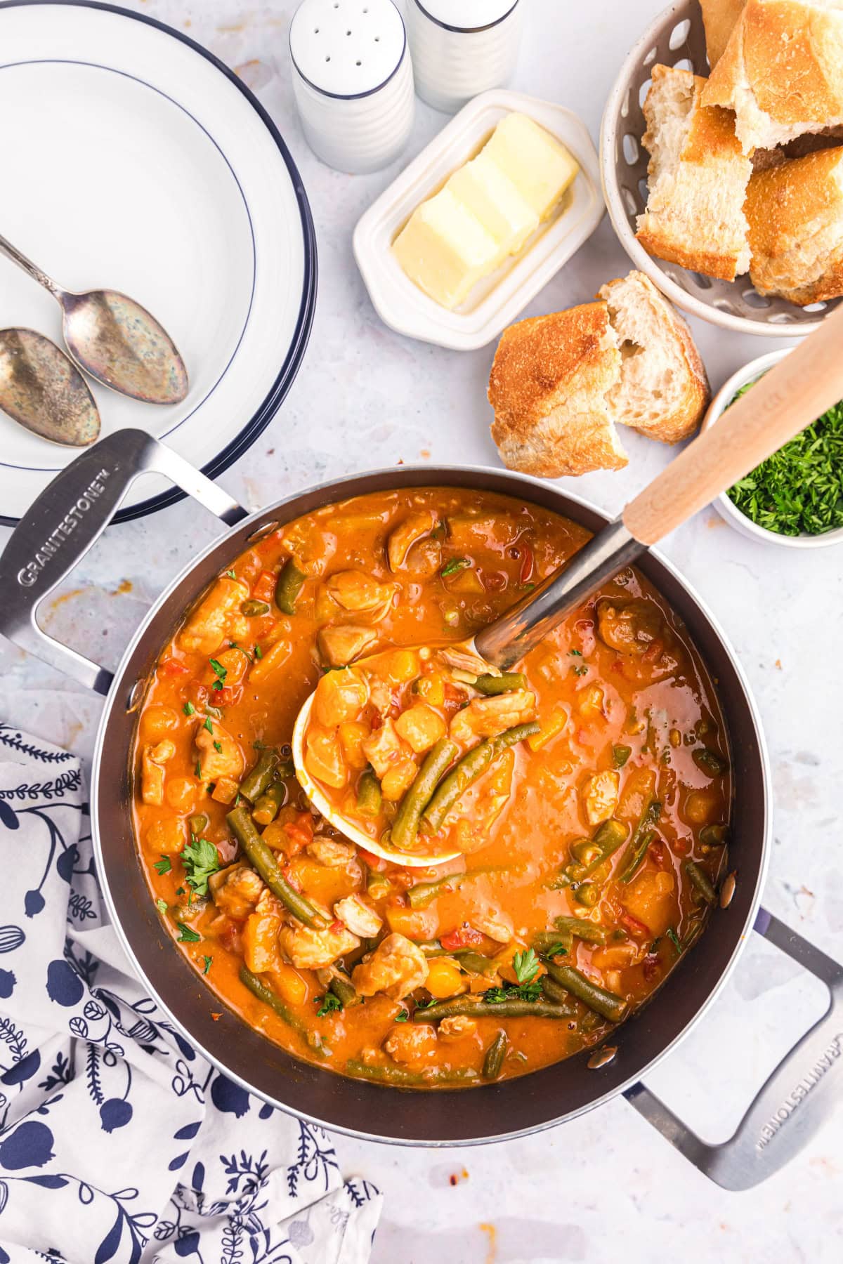 ladle sitting in pot of chicken pumpkin stew