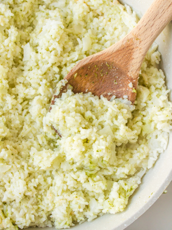 wooden spoon in a bowl of coconut ginger rice