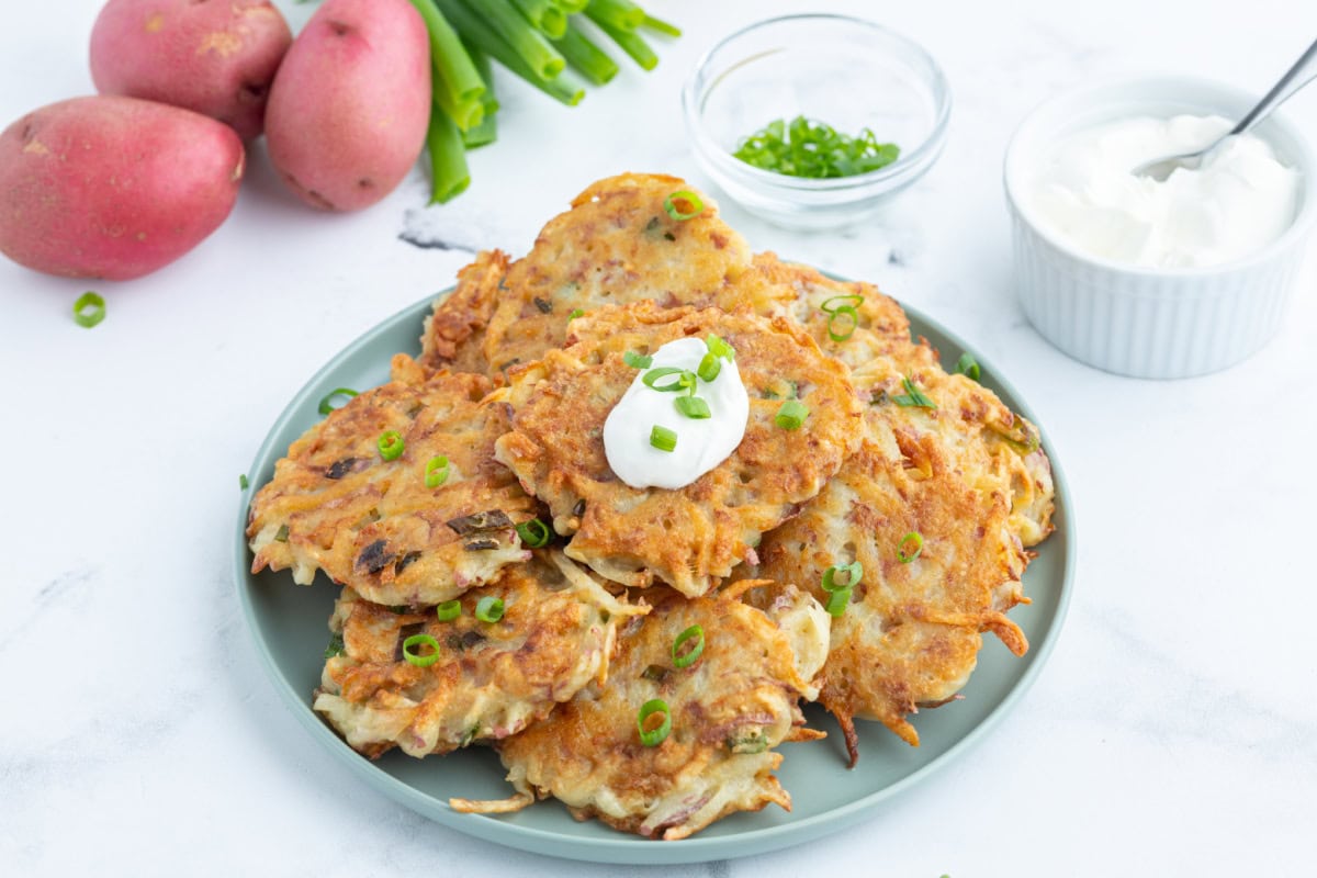 crispy potato pancakes displayed on plate and topped with sour cream