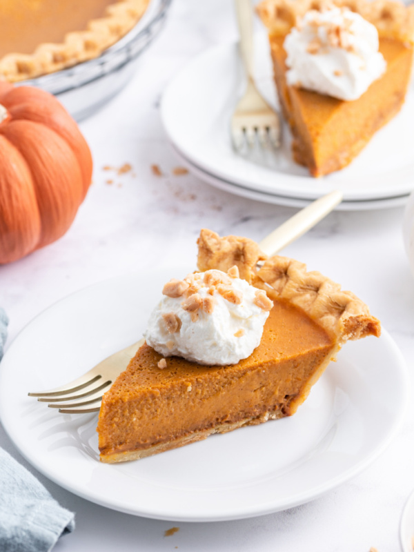 slice of dulce de leche pumpkin toffee pie on a plate topped with whipped cream