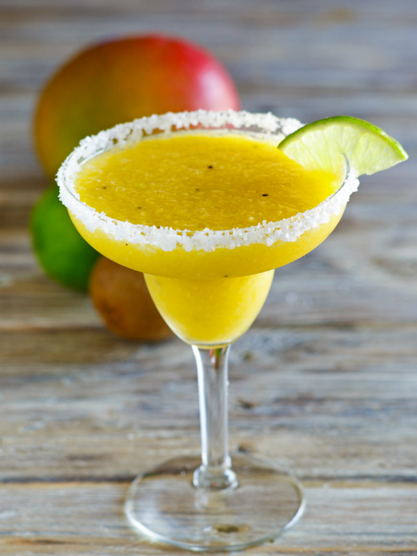 Tropical Margaritas in a margarita glass with lime wedge