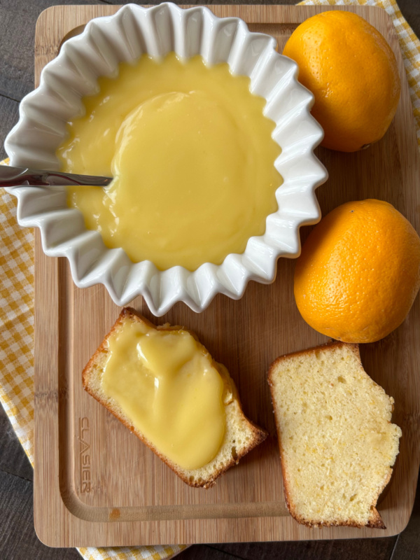 meyer lemon curd in bowl and slices of bread with lemon curd spread on