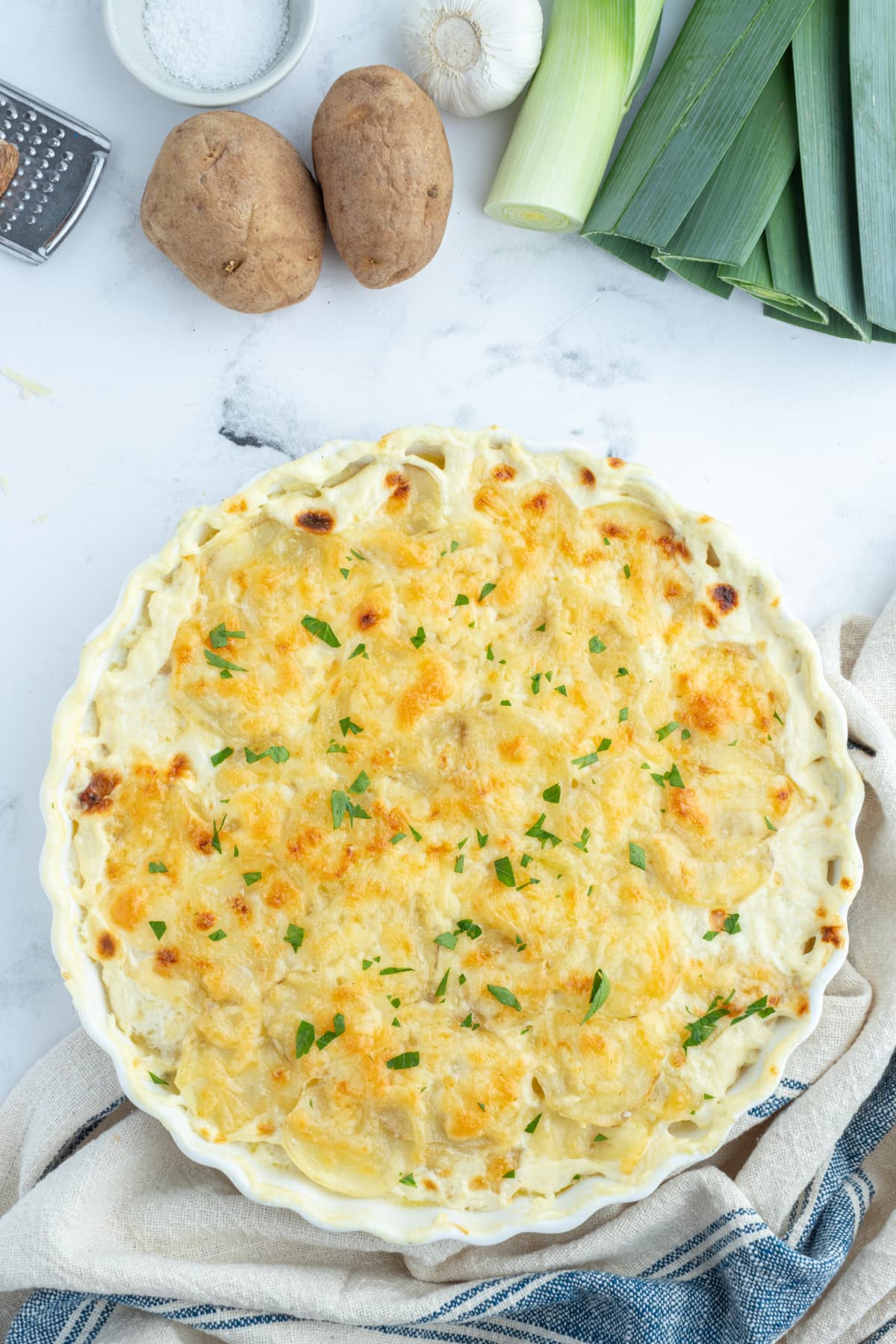 round casserole dish with potato leek gratin