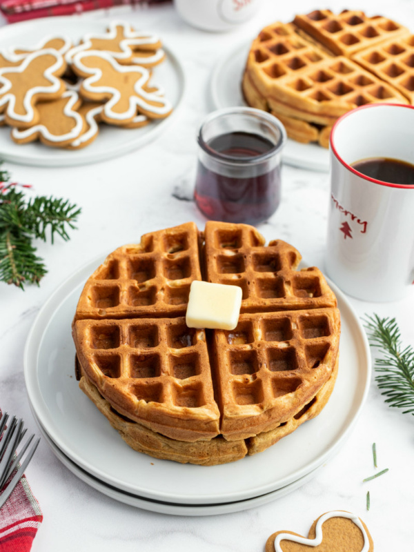 gingerbread waffles on white plate with butter