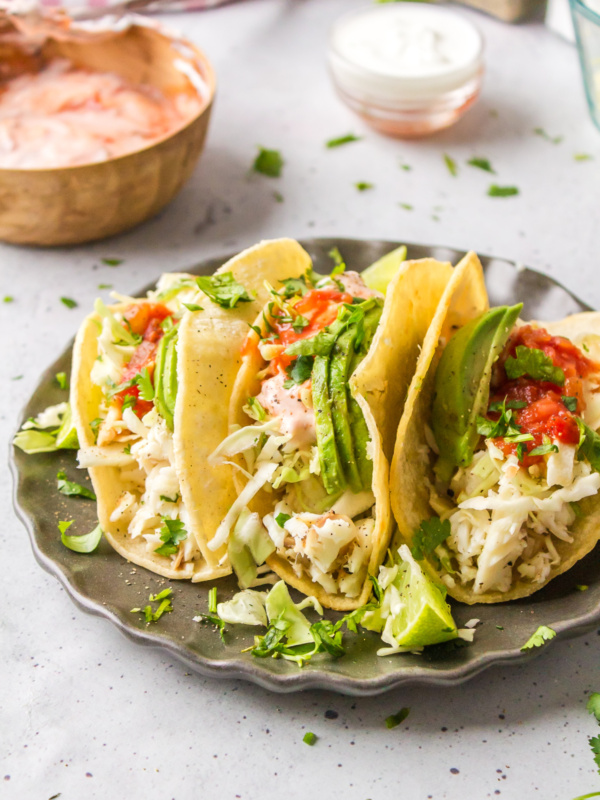 three fish tacos on a plate