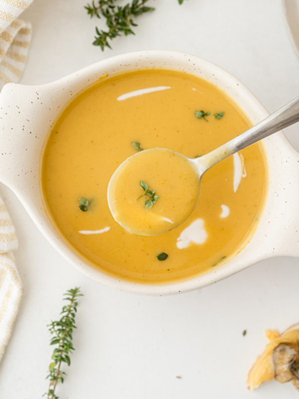 roasted pumpkin bisque in a bowl with a spoon