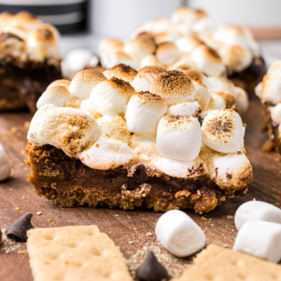 s'mores brownie with graham crackers and marshmallows in background
