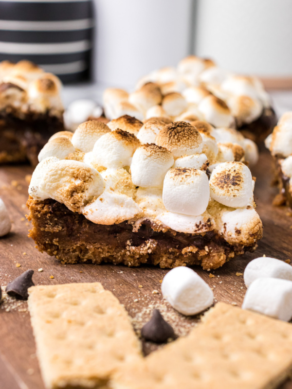 s'mores brownie with graham crackers and marshmallows in background