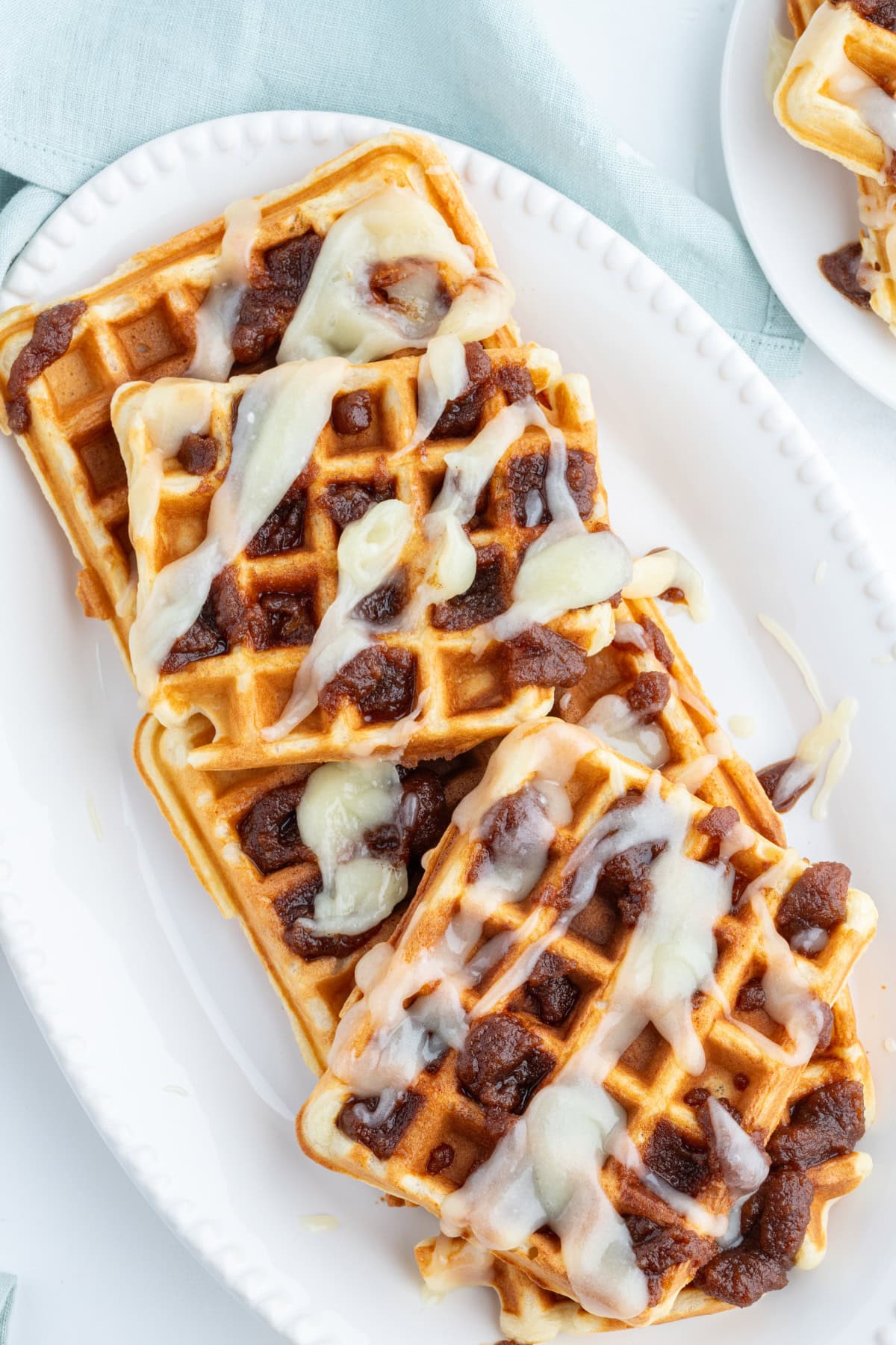 overhead shot of cinnamon roll waffles with toppings