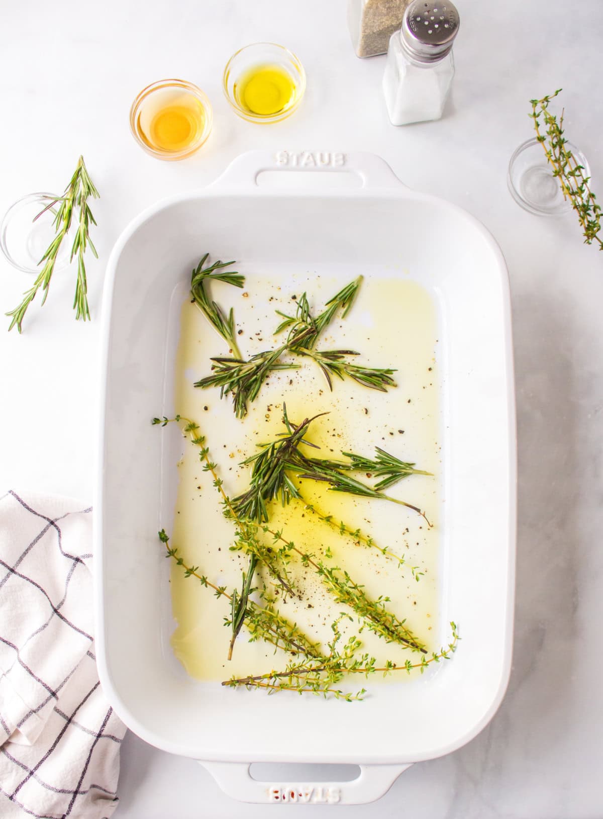 herbs in oil in a baking pan