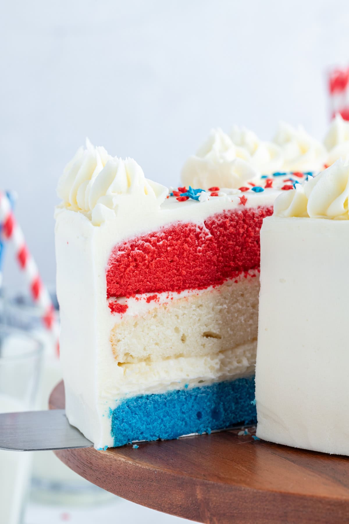 taking slice out of red white and blue cake