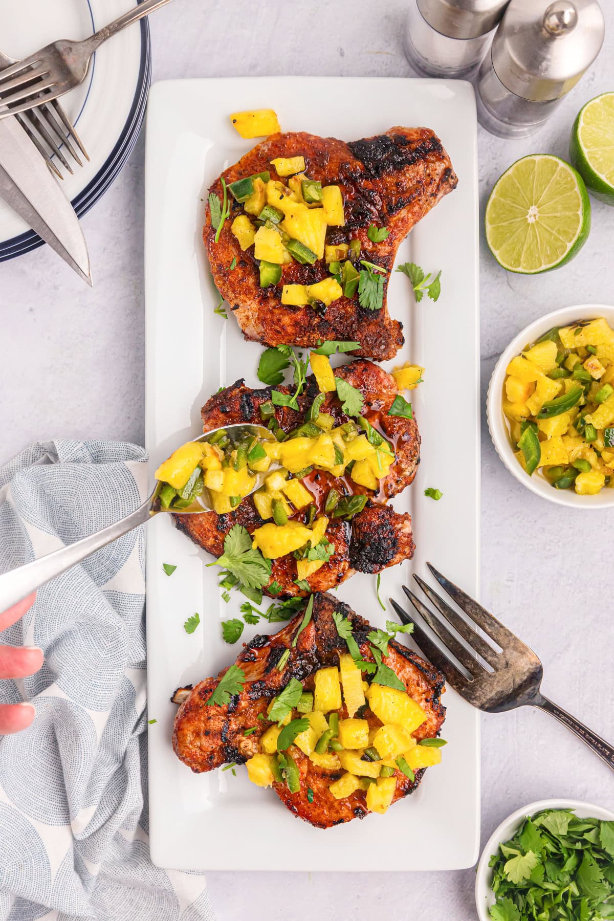 chili rubbed pork chops topped with pineapple salsa on platter