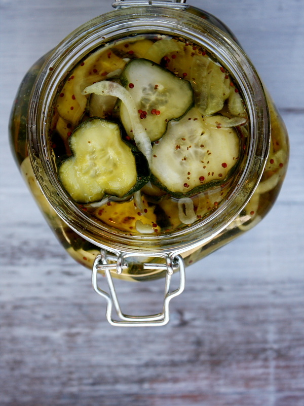 overhead shot into a jar of bread and butter pickles