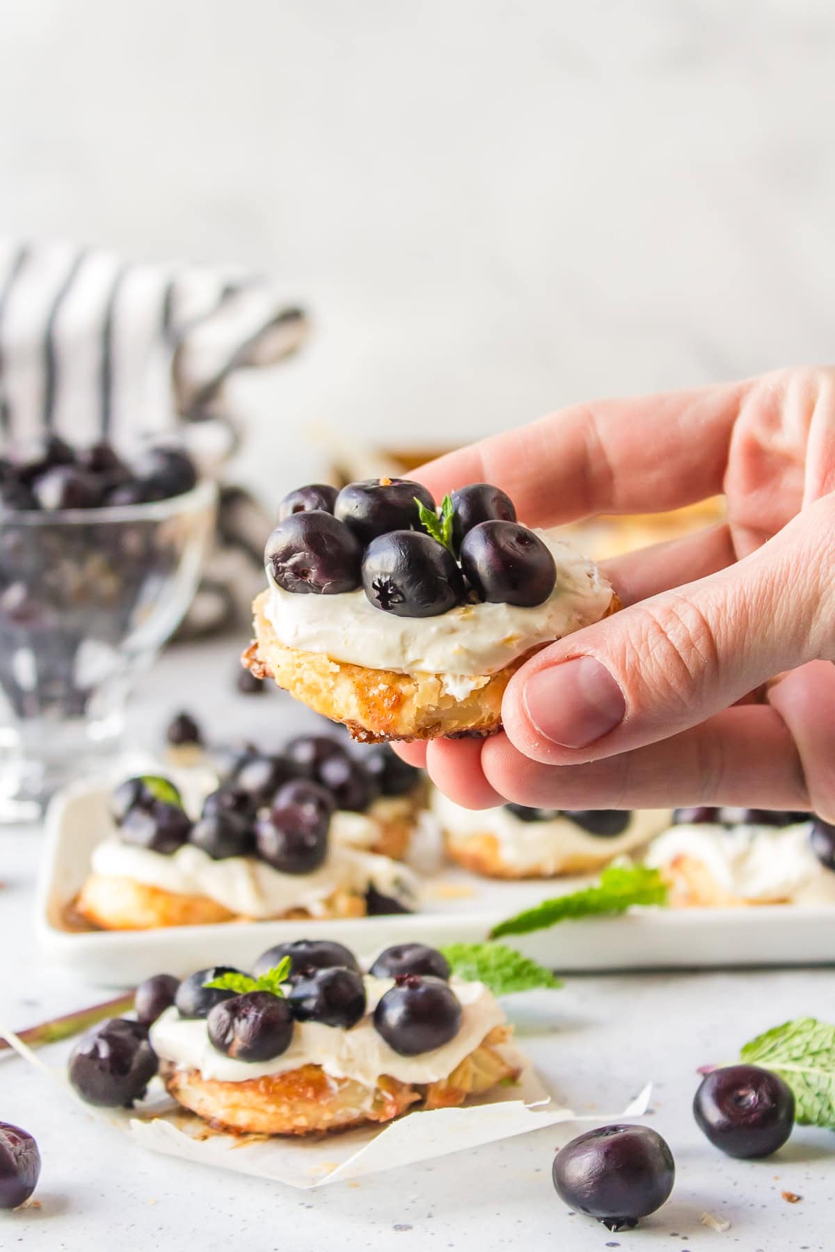 hand holding blueberry dessert bruschetta