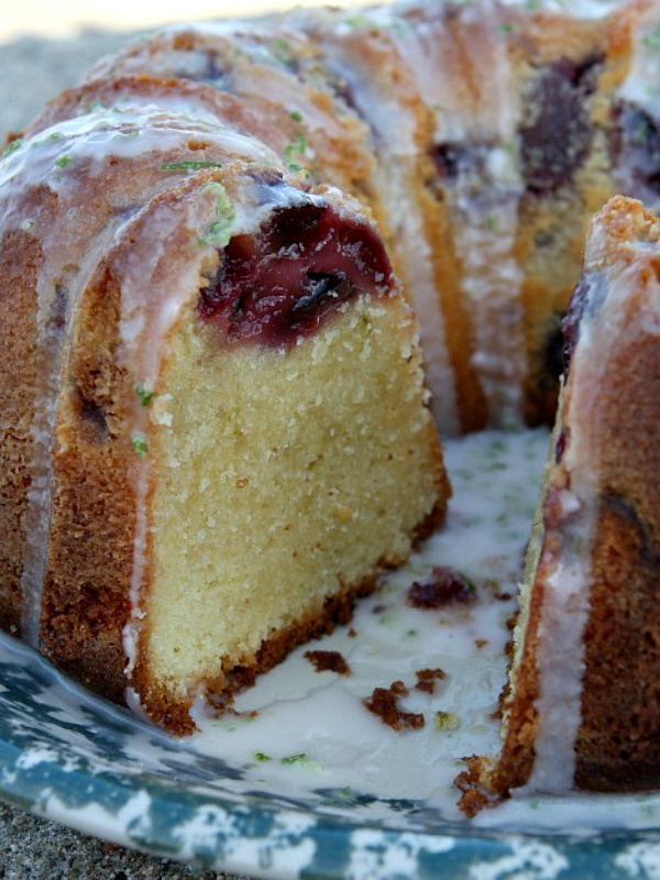 cherry limeade pound cake set on a blue and white patterned plate, cut open to see the inside