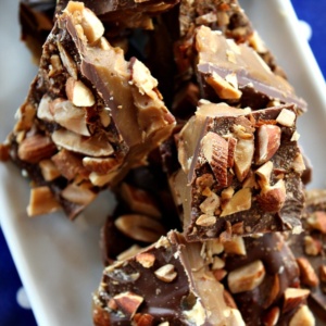 almond roca on a white plate sitting on a blue and white polka dot napkin