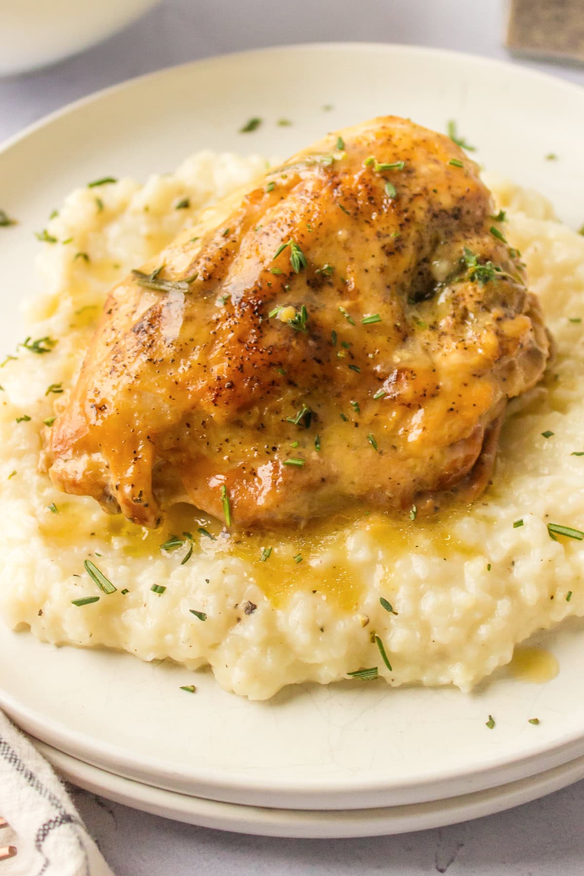 slow cooker garlic chicken on top of risotto on plate
