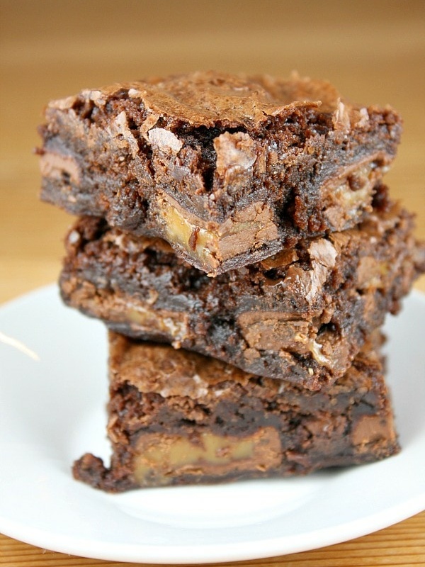 caramel brownies stacked on plate