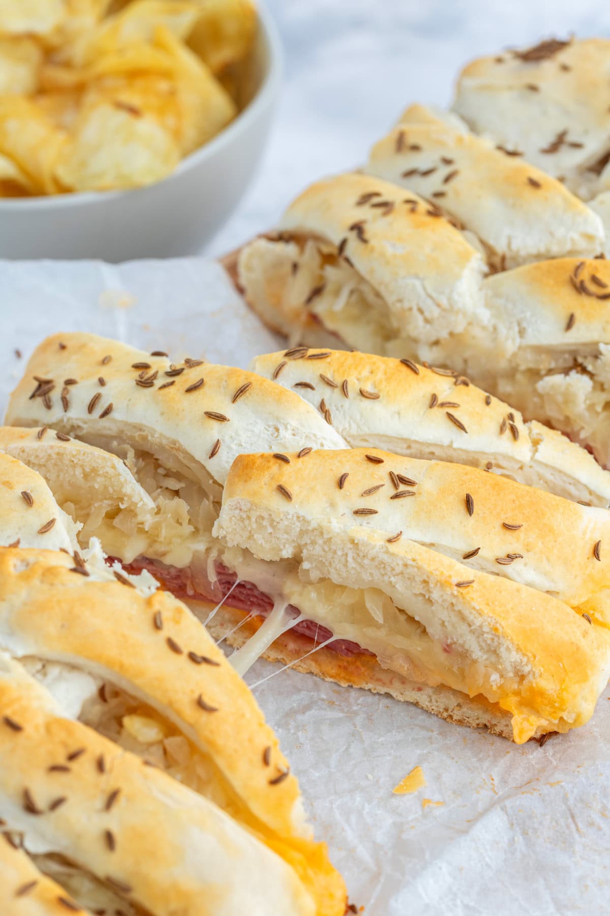 slices of reuben bread being pulled apart with gooey cheese