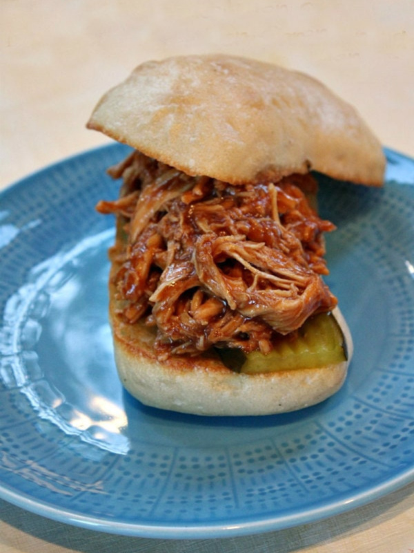 slow cooker pulled barbecue chicken sandwich on a blue plate