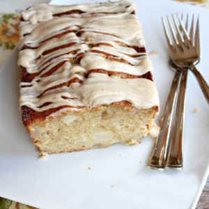 spiced pear cake on serving plate cut open to see inside