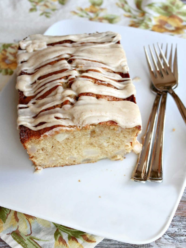 spiced pear cake on serving plate cut open to see inside