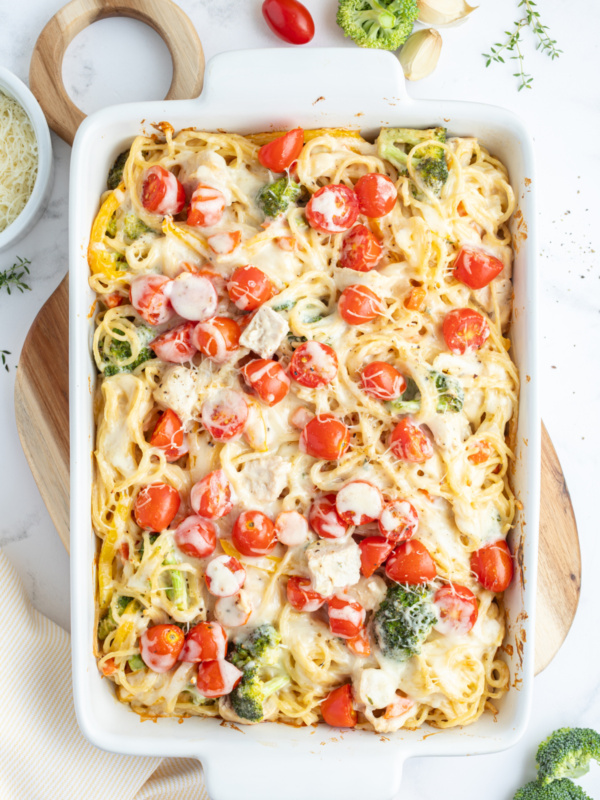 baked lemon chicken spaghetti primavera in a baking dish