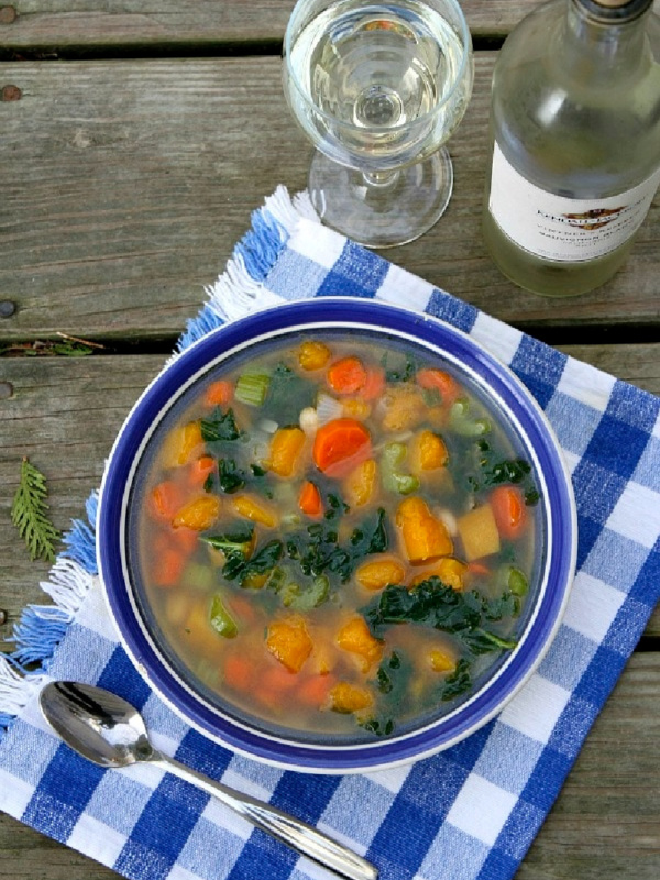 butternut squash and kale soup in a blue bowl