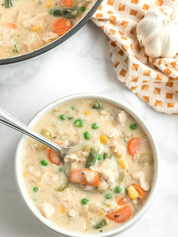 creamy chicken and rice soup in bowl with spoon