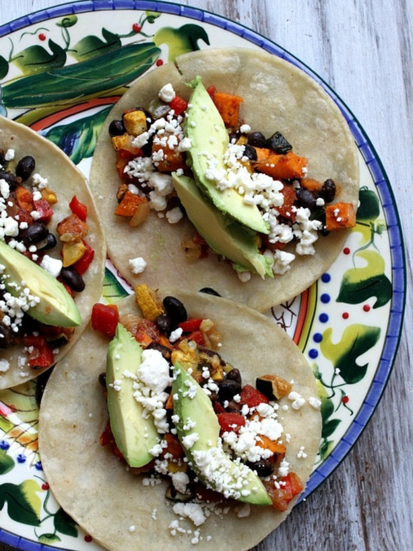 Roasted Vegetable and Black Bean Tacos open faced on plate