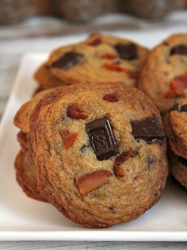 bacon bourbon chocolate chunk cookies displayed on a white plate