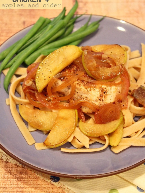 chicken with apples over pasta on plate