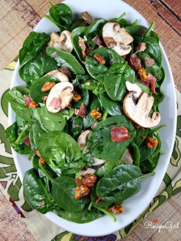 spinach salad on a white platter