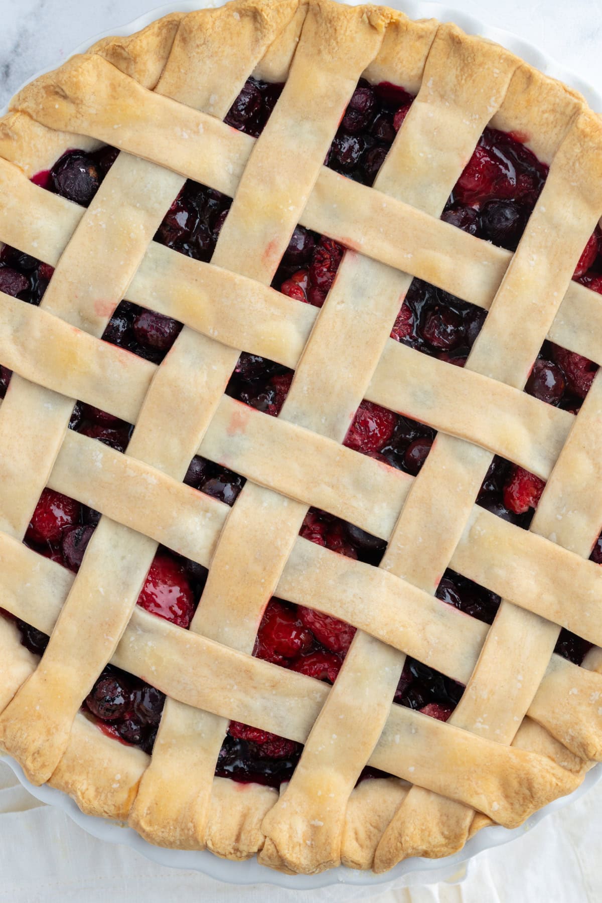 overhead shot of raspberry blueberry pie with lattice top