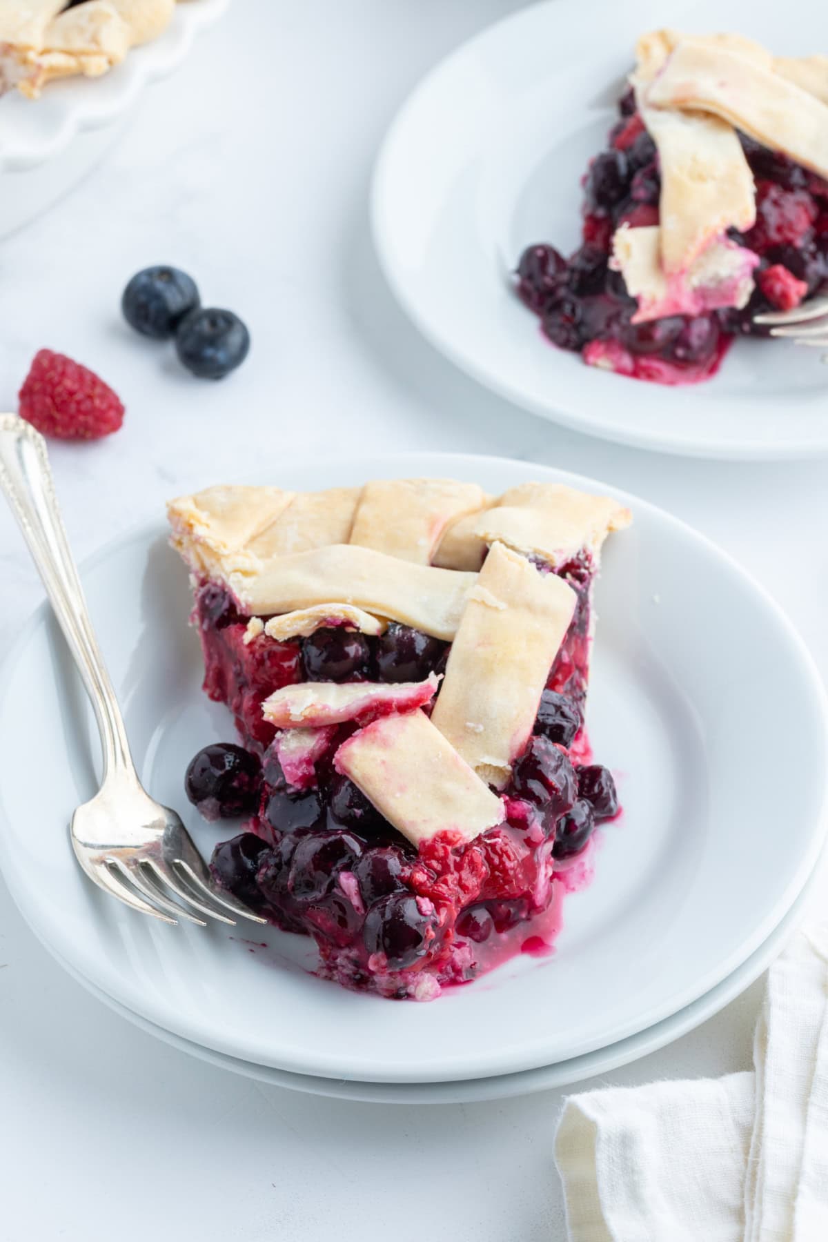 slice of raspberry blueberry pie on plate