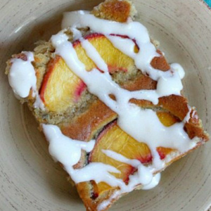 slice of fresh peach cake on a beige plate