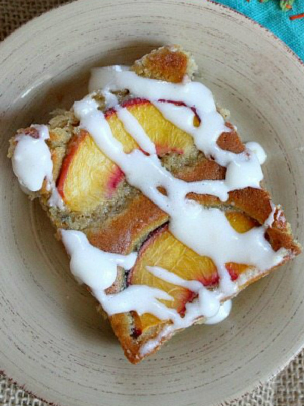 slice of fresh peach cake on a beige plate