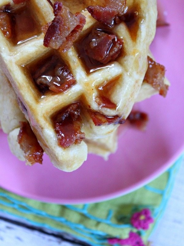 maple bacon waffles on pink plate