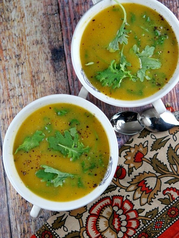 overhead shot of two bowls of butternut squash and kale soup