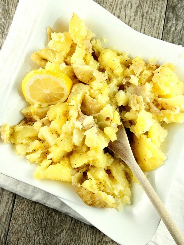 lemon smashed potatoes in a dish with a spoon