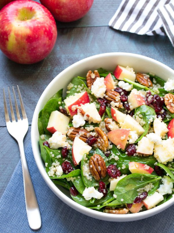 spinach and quinoa salad in a white bowl