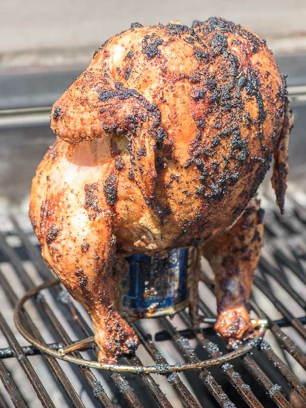 beer can chicken grilled sitting on a grill rack