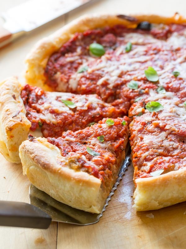 chicago deep dish pizza pulling out slices with a spatula